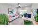 Stylish home office featuring contemporary decor, a comfortable sofa, and a large window at 32203 Mahogany Valley Dr, Wesley Chapel, FL 33543