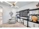 Modern home office featuring custom built-ins, stylish lighting, and comfortable seating at 32203 Mahogany Valley Dr, Wesley Chapel, FL 33543