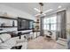 Well-lit home office with custom shelving, a comfortable seating area, and natural light at 32203 Mahogany Valley Dr, Wesley Chapel, FL 33543