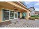 Covered patio with brick flooring, a ceiling fan, and an outdoor seating area with a view of the yard at 32203 Mahogany Valley Dr, Wesley Chapel, FL 33543