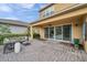 Covered brick patio with a ceiling fan and sliding glass doors offering seamless indoor-outdoor living at 32203 Mahogany Valley Dr, Wesley Chapel, FL 33543