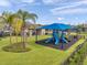 Community playground featuring slides, climbing structures, and a shaded area for fun and recreation at 32203 Mahogany Valley Dr, Wesley Chapel, FL 33543
