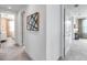 Hallway with neutral paint and carpet, and doorways that lead to a bedroom and a living space at 32203 Mahogany Valley Dr, Wesley Chapel, FL 33543