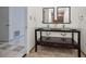 Stylish bathroom featuring glass vessel sinks, dual mirrors, and tile flooring at 3411 Glossy Ibis Ct, Palm Harbor, FL 34683