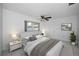 Bright bedroom with white walls, ceiling fan, comfortable queen size bed and natural light from a window at 3411 Glossy Ibis Ct, Palm Harbor, FL 34683