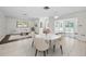 Bright dining area flowing into living room with access to the pool area at 3411 Glossy Ibis Ct, Palm Harbor, FL 34683