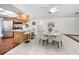Open dining area with marble table, bar seating, and stainless steel appliances at 3411 Glossy Ibis Ct, Palm Harbor, FL 34683