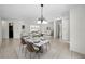 Open-concept dining room with tile floors, contemporary furniture, and natural light at 3411 Glossy Ibis Ct, Palm Harbor, FL 34683
