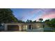 Charming single-story home with a well-manicured lawn, an attached garage, and a welcoming front entrance at 3411 Glossy Ibis Ct, Palm Harbor, FL 34683