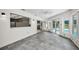 Open concept Florida room with tile floors, views of the pool area and access to the backyard at 3411 Glossy Ibis Ct, Palm Harbor, FL 34683