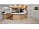 Well-lit kitchen with light wood cabinets, white countertops and tiled floors at 3411 Glossy Ibis Ct, Palm Harbor, FL 34683