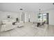 Bright and spacious living room featuring neutral decor, tile flooring, and a view of the outdoors at 3411 Glossy Ibis Ct, Palm Harbor, FL 34683