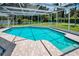 Inviting screened-in pool with tile patio perfect for outdoor entertaining at 3411 Glossy Ibis Ct, Palm Harbor, FL 34683