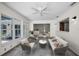 Bright sun room with tile flooring, comfortable seating area and a view to the backyard at 3411 Glossy Ibis Ct, Palm Harbor, FL 34683