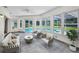 Cozy sunroom with ample windows, comfortable seating, and views of the pool at 3411 Glossy Ibis Ct, Palm Harbor, FL 34683