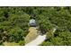 A secluded two-story home is surrounded by lush greenery, with a long private driveway at 34147 Ringwalt Dr, Dade City, FL 33523