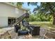 Exterior view of home's backyard featuring a stone seating area and firepit at 34147 Ringwalt Dr, Dade City, FL 33523