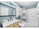 Charming bathroom with vanity, framed mirror, and shower-tub combo at 34147 Ringwalt Dr, Dade City, FL 33523