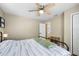 Bright bedroom with ceiling fan, wood-look flooring, and neutral paint at 34147 Ringwalt Dr, Dade City, FL 33523