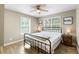Well-lit bedroom with wood-look flooring, ceiling fan, and two windows at 34147 Ringwalt Dr, Dade City, FL 33523