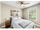 Cozy bedroom with neutral colors, wood-look floors and a ceiling fan at 34147 Ringwalt Dr, Dade City, FL 33523