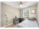Comfortable bedroom with a gray workstation, wood-look floors, and a ceiling fan at 34147 Ringwalt Dr, Dade City, FL 33523
