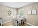 Bright dining area with a modern table set, neutral walls, and lots of natural light at 34147 Ringwalt Dr, Dade City, FL 33523