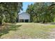Spacious backyard with a stilt house surrounded by lush trees at 34147 Ringwalt Dr, Dade City, FL 33523