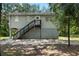 Charming two-story home on stilts with a well-maintained yard and stairs to front door at 34147 Ringwalt Dr, Dade City, FL 33523