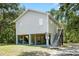 Two-story home with plenty of outdoor parking under the house and stairs leading to front door at 34147 Ringwalt Dr, Dade City, FL 33523