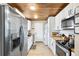 Modern kitchen with stainless steel appliances, white cabinets, and a butcher block countertop at 34147 Ringwalt Dr, Dade City, FL 33523