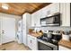 Bright kitchen features white cabinetry, stainless steel appliances, and butcher block countertops at 34147 Ringwalt Dr, Dade City, FL 33523