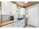 Beautiful kitchen featuring white cabinets, butcher block counters and stainless steel appliances at 34147 Ringwalt Dr, Dade City, FL 33523