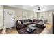Open-concept living room with a comfortable sectional sofa, and dining area by the door at 34147 Ringwalt Dr, Dade City, FL 33523