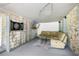 Cozy living area with comfy sofa, dart board and flatscreen TV at 34147 Ringwalt Dr, Dade City, FL 33523