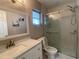 Modern bathroom with glass enclosed shower, and white vanity with quartz counters and decorative mirror at 3803 43Rd N Ave, St Petersburg, FL 33714