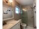 Modern bathroom with glass enclosed shower, and white vanity with quartz counters and decorative mirror at 3803 43Rd N Ave, St Petersburg, FL 33714