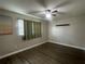 Cozy bedroom featuring ceiling fan, window with blinds and curtains, and modern hard surface floors at 3803 43Rd N Ave, St Petersburg, FL 33714