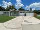 Charming one-story home with stone facade, well-kept lawn, an attached garage and long driveway at 3803 43Rd N Ave, St Petersburg, FL 33714
