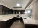 Kitchen featuring dark cabinetry, stainless steel appliances, quartz counters, tile backsplash and a skylight at 3803 43Rd N Ave, St Petersburg, FL 33714