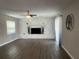 Living room with stone fireplace, ceiling fan and neutral paint for easy customization at 3803 43Rd N Ave, St Petersburg, FL 33714