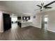 Open-concept living space with dark wood floors leading to a modern kitchen and other rooms at 3803 43Rd N Ave, St Petersburg, FL 33714