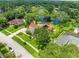 An aerial view showcasing a well-maintained home with a pond and lush landscaping, offering a serene backyard at 4118 Carrollwood Village Dr, Tampa, FL 33618