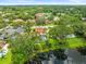 Aerial view of the property, showcasing a pond, pool, mature trees and landscaping, in a desirable neighborhood at 4118 Carrollwood Village Dr, Tampa, FL 33618