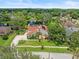 Stunning aerial view of a well-maintained home featuring mature landscaping and a serene pond at 4118 Carrollwood Village Dr, Tampa, FL 33618