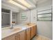 Bathroom with double sinks, a large mirror, and plenty of natural light from the window at 4118 Carrollwood Village Dr, Tampa, FL 33618