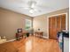 Bedroom featuring hardwood floors, neutral colors, a ceiling fan, and a view to the outdoors at 4118 Carrollwood Village Dr, Tampa, FL 33618