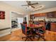 Charming dining area with wood floors, ceiling fan, and access to the living room at 4118 Carrollwood Village Dr, Tampa, FL 33618