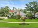Charming home featuring lush landscaping, mature trees, and a well-maintained lawn at 4118 Carrollwood Village Dr, Tampa, FL 33618