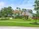 Charming home with tropical landscaping, lush green lawn, and unique architectural design at 4118 Carrollwood Village Dr, Tampa, FL 33618